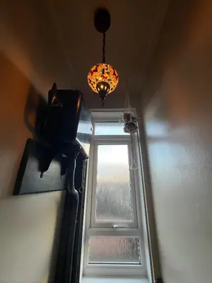 a room with a window and a chandelier at Reevell Avenue in Liverpool
