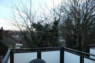 a tree sitting on top of a balcony at Reevell Avenue in Liverpool