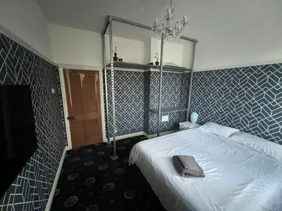 a bedroom with a white bed and a mirror at Reevell Avenue in Liverpool