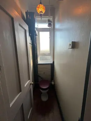 a small bathroom with a toilet and a window at Reevell Avenue in Liverpool