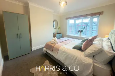 a bedroom with a bed and a window at Driftwood Bay in Fleetwood