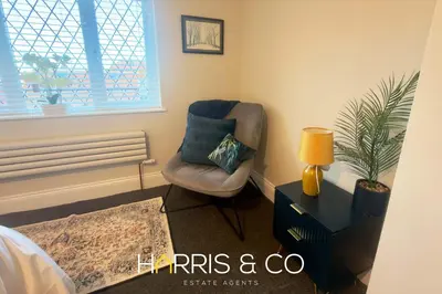 a living room with a chair and a lamp at Driftwood Bay in Fleetwood