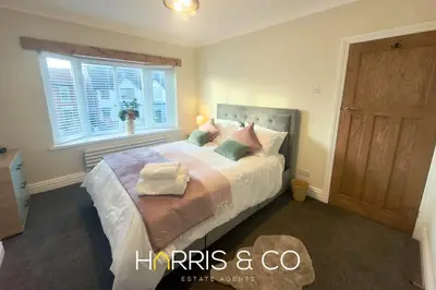 a bedroom with a bed with pillows and a window at Driftwood Bay in Fleetwood