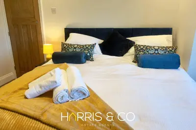 a bed with two towels and pillows on it at Driftwood Bay in Fleetwood