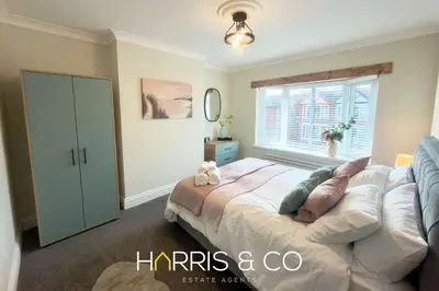a bedroom with a bed and a window at Driftwood Bay in Fleetwood