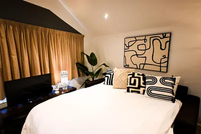 a bedroom with a bed and a desk with a television at Starr Place in Liverpool