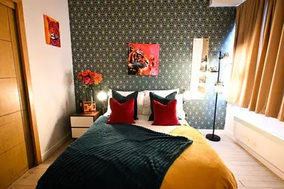 a bedroom with a bed with red pillows at Starr Place in Liverpool