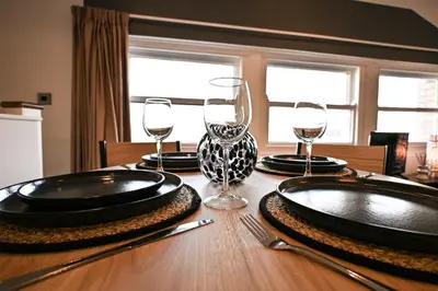 a table with plates and wine glasses on it at Starr Place in Liverpool