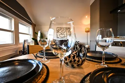 a table with wine glasses and plates on it at Starr Place in Liverpool