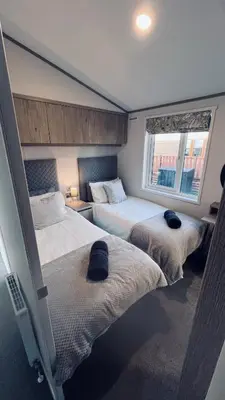 a bedroom with two beds and a window at Blue Water Retreats in Carnforth