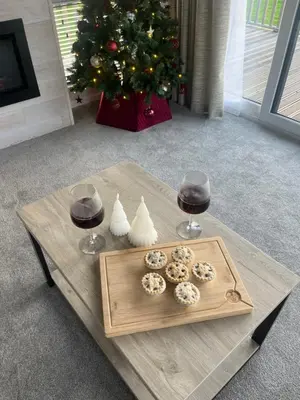 a table with a tray of donuts and two glasses of wine at Blue Water Retreats in Carnforth