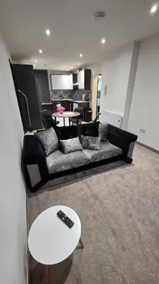 a living room with a couch and a table at Modern 2-Bed High Spec Flat Apartment in Town Centre in Blackburn