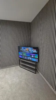 a flat screen tv in a corner of a room at Modern 2-Bed High Spec Flat Apartment in Town Centre in Blackburn