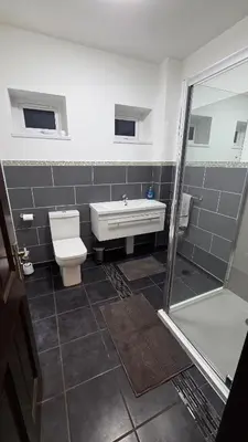 a bathroom with a toilet and a sink and a shower at Modern 2-Bed High Spec Flat Apartment in Town Centre in Blackburn