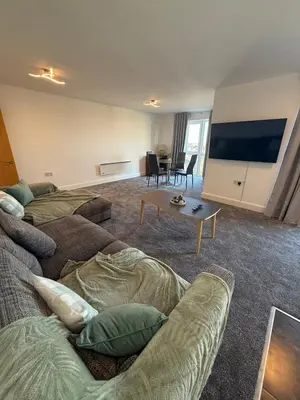 a living room with a couch and a flat screen tv at Southport Coastal View Retreat in Southport