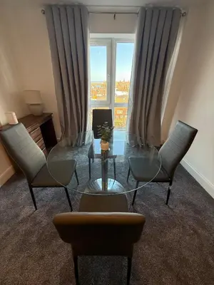 a living room with a table and chairs and a window at Southport Coastal View Retreat in Southport