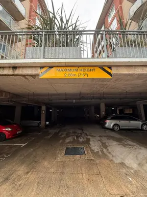 a parking garage with two cars parked in it at Southport Coastal View Retreat in Southport