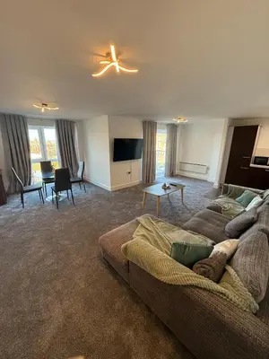 a living room with a couch and a tv at Southport Coastal View Retreat in Southport