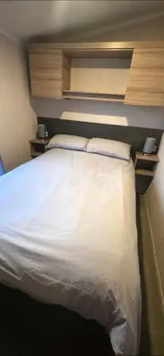 a bedroom with a large white bed with two pillows at S & S Retreat in Heysham