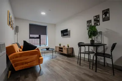 a living room with a couch and a table at Modern Apartment Liverpool City Centre in Liverpool