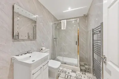 a bathroom with a sink and a toilet and a shower at The Slater Pad - Party Apartment in Liverpool City Centre in Liverpool