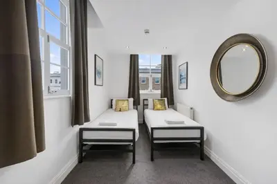 a waiting room with two chairs and a mirror at The Slater Pad - Party Apartment in Liverpool City Centre in Liverpool