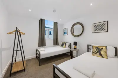 a bedroom with two beds and a mirror at The Slater Pad - Party Apartment in Liverpool City Centre in Liverpool