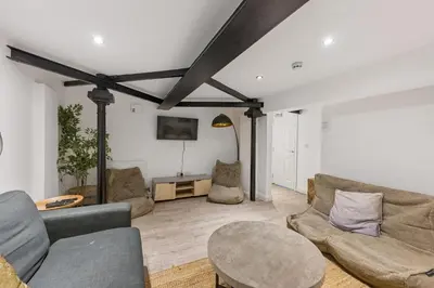 a living room with two couches and a table at The Slater Pad - Party Apartment in Liverpool City Centre in Liverpool
