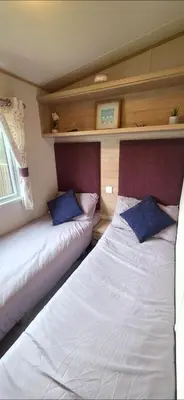 two beds in a room with two pillows at Joy & Mick's Happy Place in Morecambe