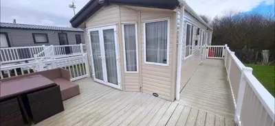 a large deck with a house with a porch at Joy & Mick's Happy Place in Morecambe