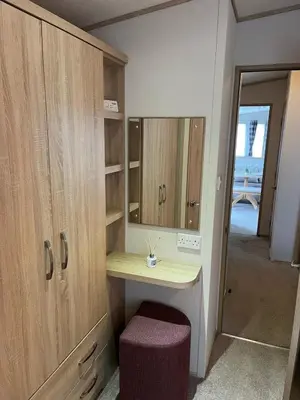 a dressing room with a vanity and a mirror at Joy & Mick's Happy Place in Morecambe