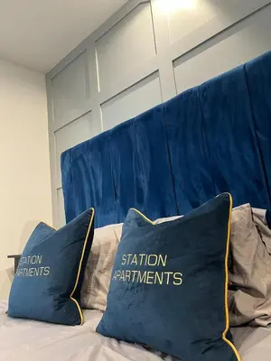 a bed with two pillows on top of it at Station View Apartments in Blackpool