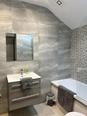 a bathroom with a sink and a bath tub at Station View Apartments in Blackpool