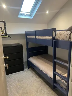 a bedroom with two bunk beds and a skylight at Station View Apartments in Blackpool
