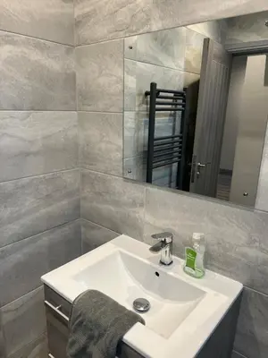a bathroom with a sink and a mirror at Station View Apartments in Blackpool