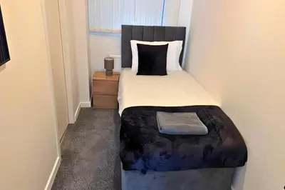 a bedroom with a large bed with a black headboard at 1 Bedroom apartment by Brookland Stays Serviced Accommodation & Short Lets in Blackpool in Blackpool