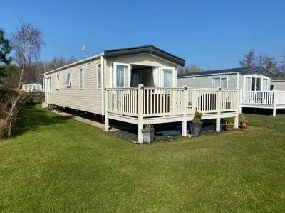 a mobile home with a porch and a deck at Haven Lakeside View Caravan in Flookburgh