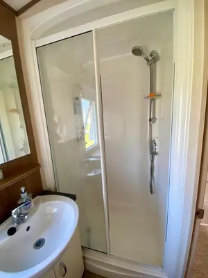 a bathroom with a shower and a sink at Haven Lakeside View Caravan in Flookburgh