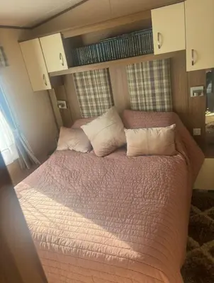 a bedroom with a large bed in a room at Haven Lakeside View Caravan in Flookburgh