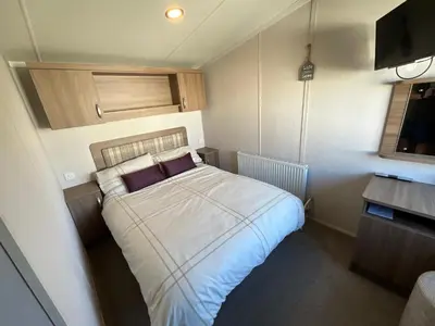 a bedroom with a bed in a small room at Lakeland Holiday Home in Flookburgh