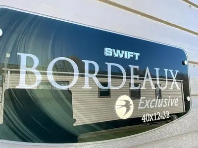 a sign on the side of a building with the words swift berry visible at Lakeland Holiday Home in Flookburgh