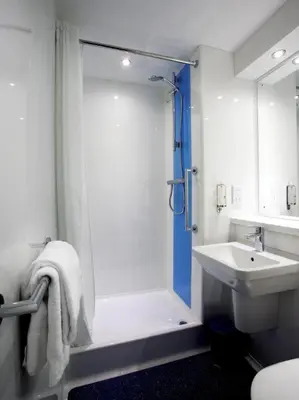 a bathroom with a shower and a sink at Travelodge Liverpool Central Exchange Street in Liverpool