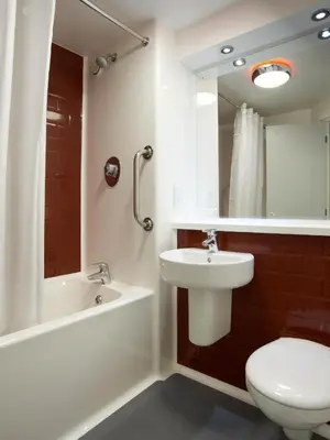 a bathroom with a sink and a toilet and a mirror at Travelodge Liverpool Central Exchange Street in Liverpool