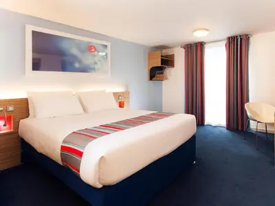 a bedroom with a large bed in a hotel room at Travelodge Liverpool Central Exchange Street in Liverpool