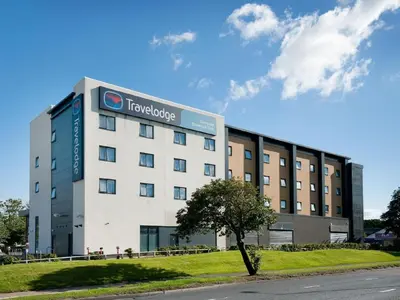a building with a sign on the side of it at Travelodge Liverpool Stonedale Park in Liverpool
