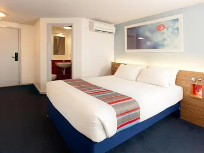 a bedroom with a large bed in a room at Travelodge Liverpool Stonedale Park in Liverpool