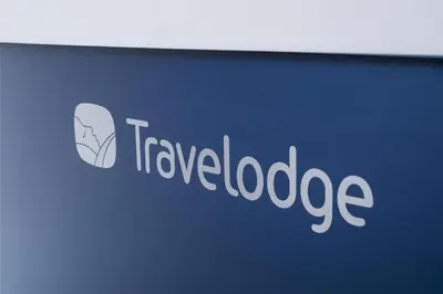a sign for a travel loadage company on a wall at Travelodge Liverpool Stonedale Park in Liverpool