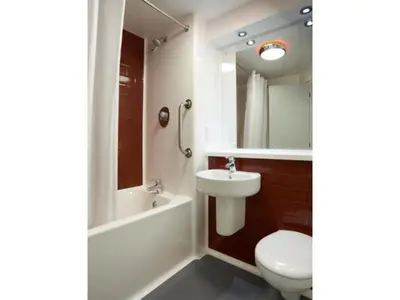 a bathroom with a sink and a toilet and a bath tub at Travelodge Morecambe in Morecambe