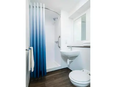 a bathroom with a toilet and a sink at Travelodge Blackpool South Shore in Blackpool