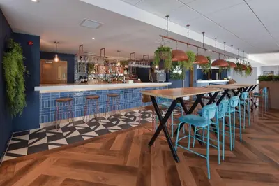 a bar with a table and chairs in a restaurant at Travelodge Blackpool South Shore in Blackpool